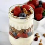 closeup of Easy Granola Parfait with berries in background