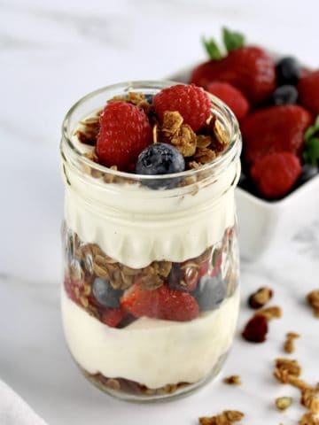 closeup of Easy Granola Parfait with berries in background