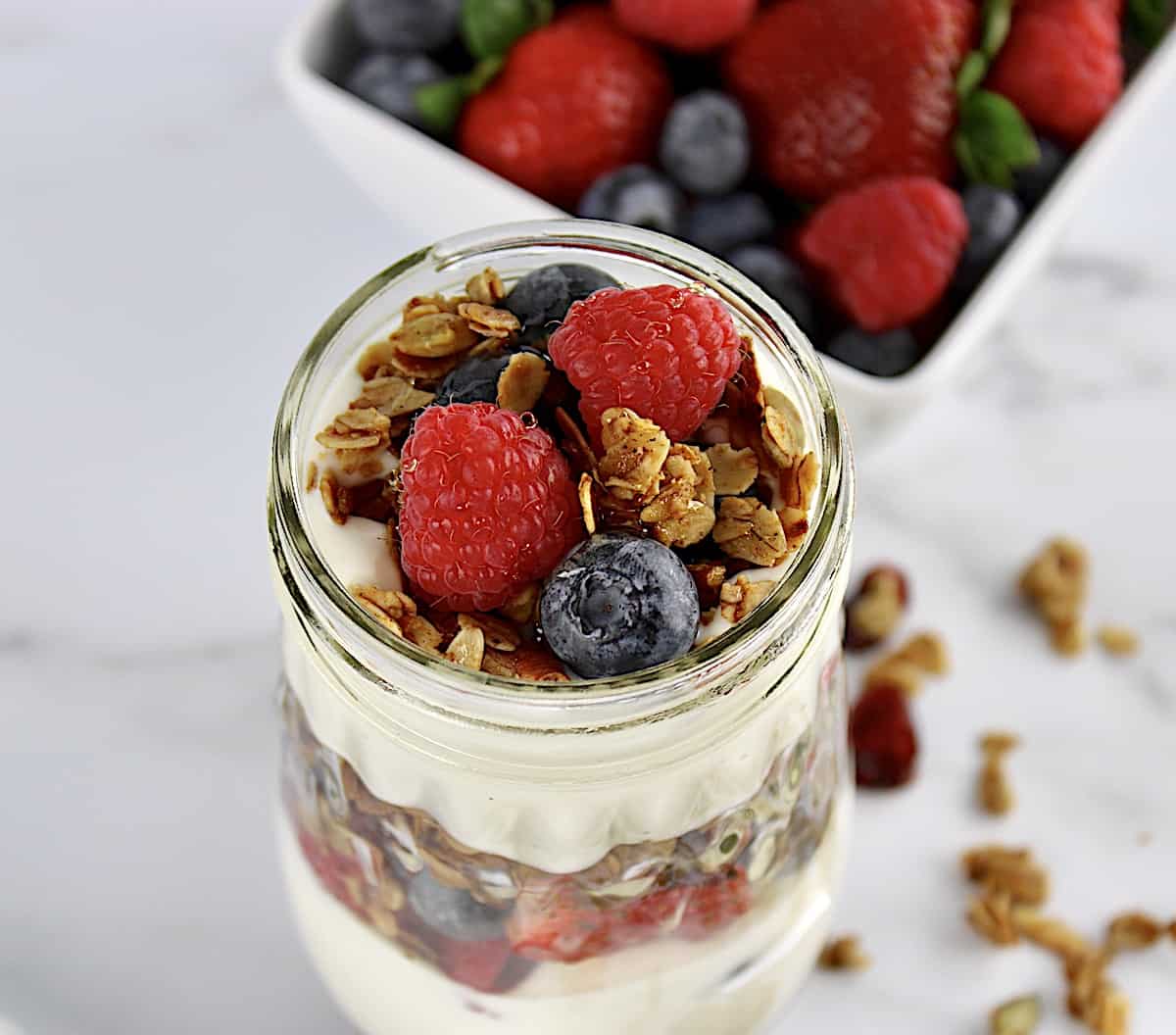 overhead view of Easy Granola Parfait with berries in background