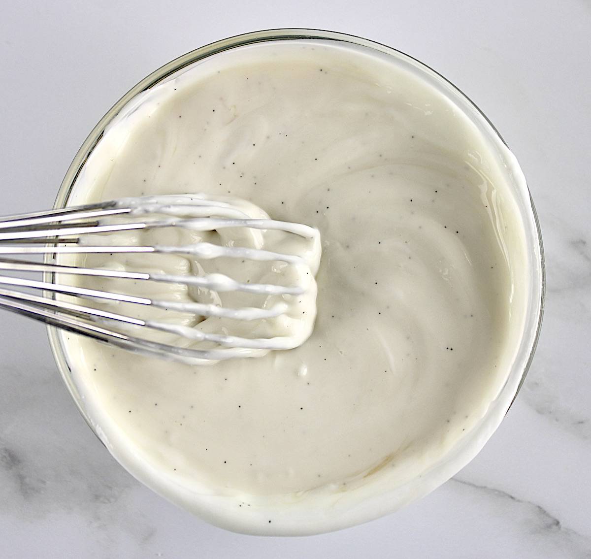 vanilla Greek yogurt in glass bowl with whisk