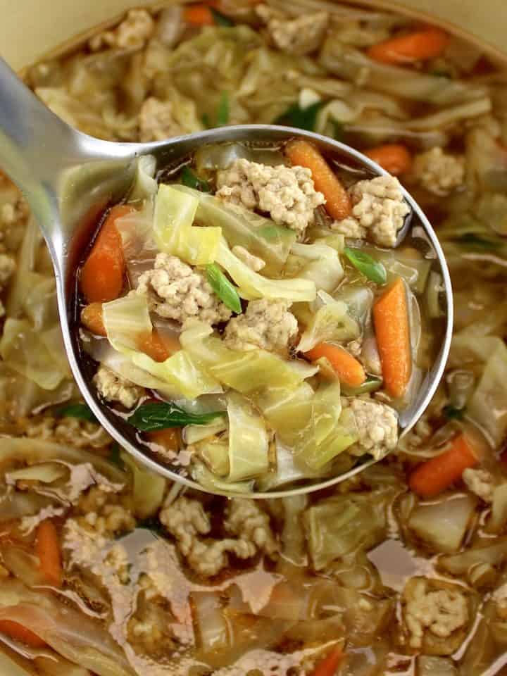 Egg Roll Soup in silver ladle over pot of soup