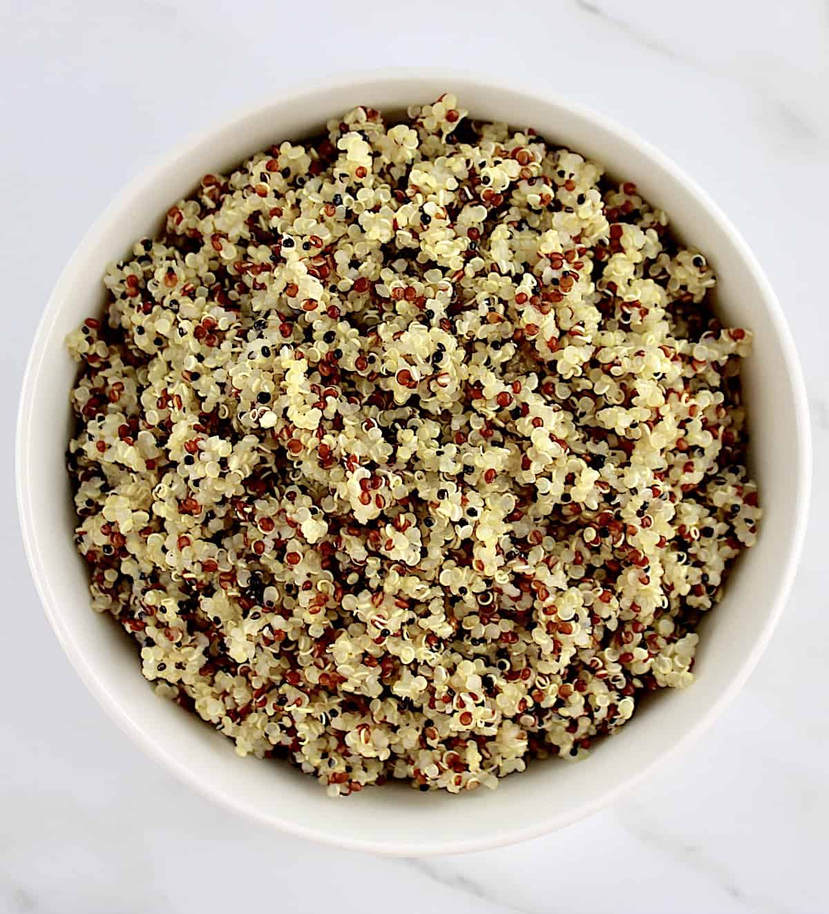 overhead view of cooked quinoa in white bowl