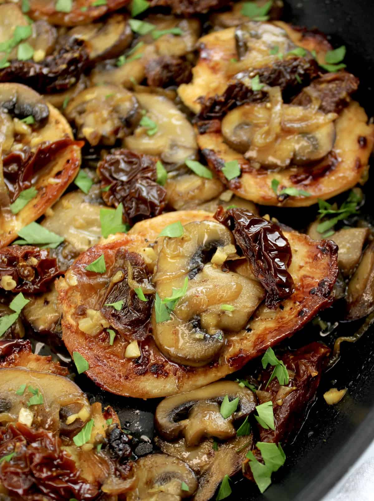 closeup of Mushroom Chicken with Sun-Dried Tomatoes in skillet