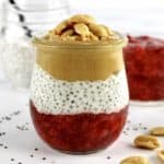 side view of Peanut butter and Jelly Chia Pudding with peanuts on top