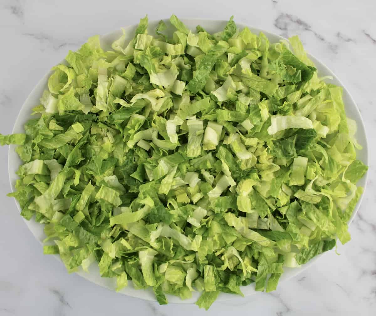 shredded romaine lettuce on platter