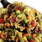 Cowboy Caviar Pasta Salad being held up by black serving spoon