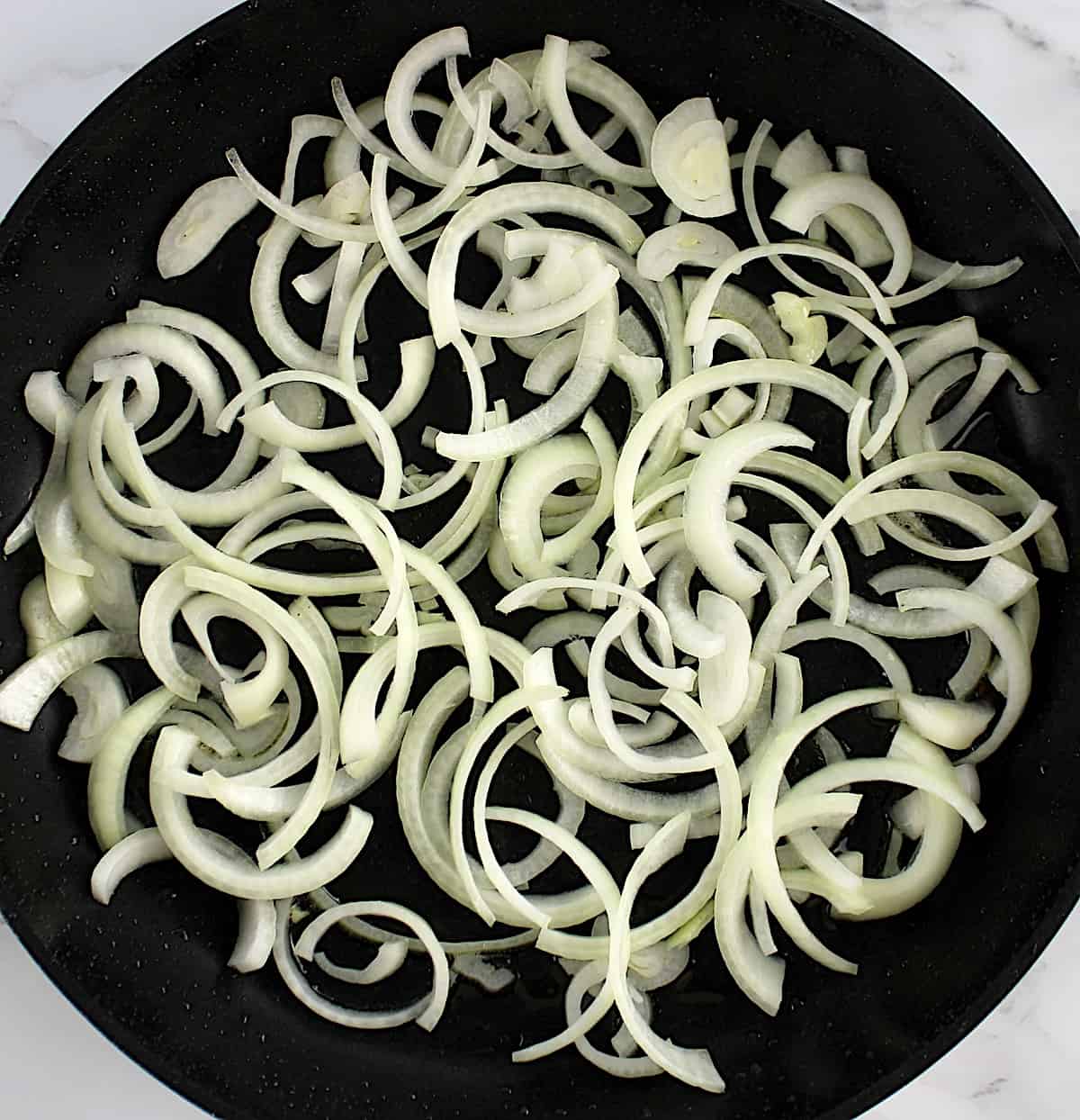 sliced onion in skillet uncooked