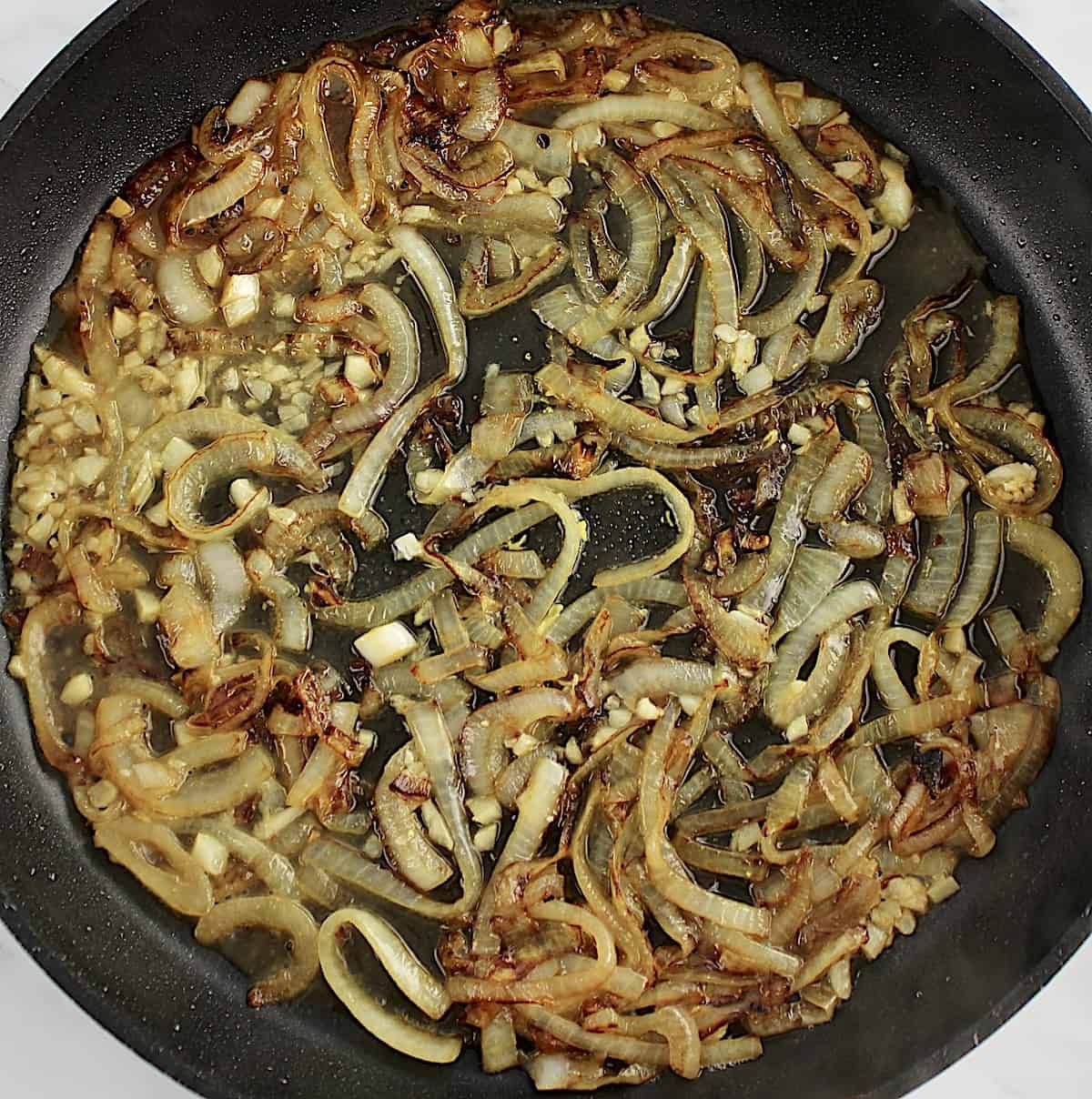 caramelized onions with chicken broth in skillet