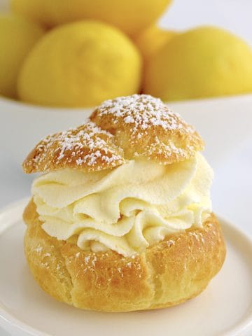 closeup of Lemon Cream Puff with lemons in background