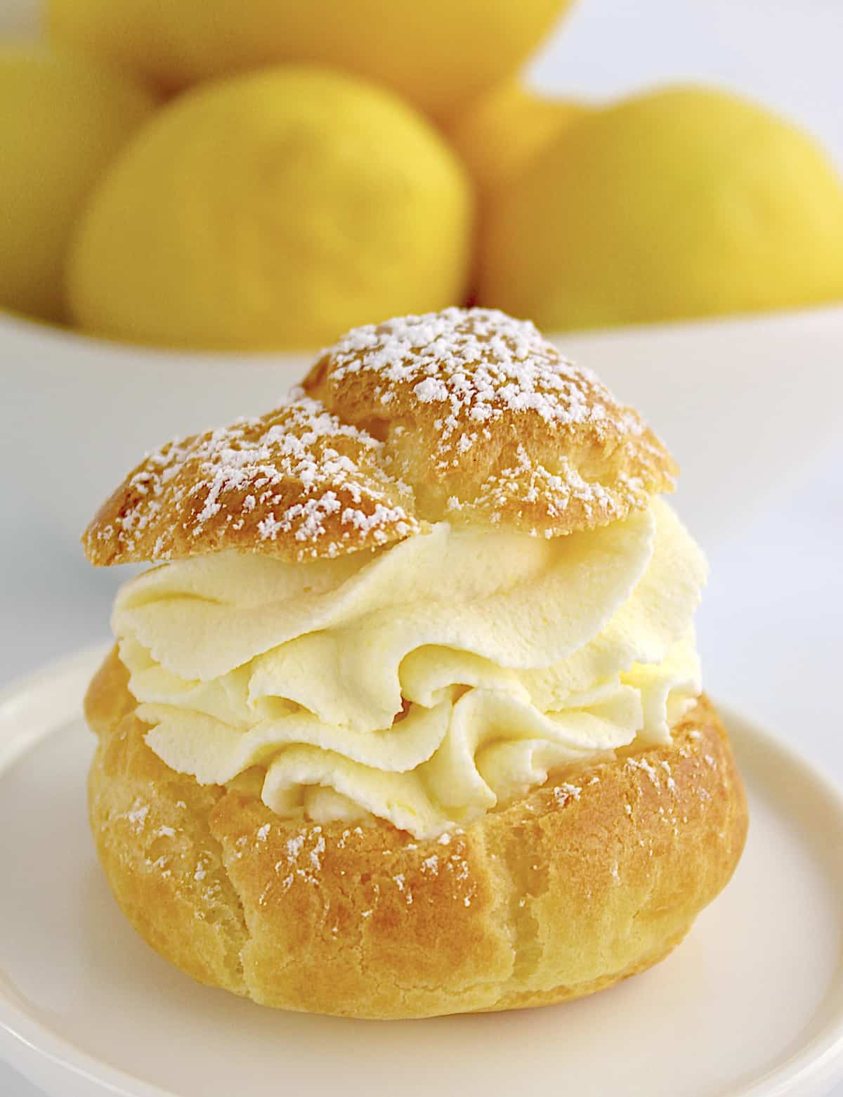 closeup of Lemon Cream Puff with lemons in background