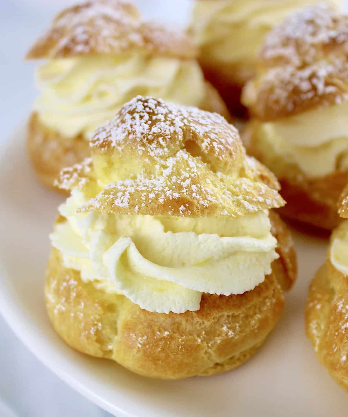 Lemon Cream Puffs closeup with powdered sugar on tops