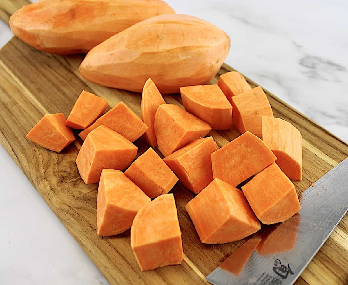 chopped sweet potatoes on cutting board