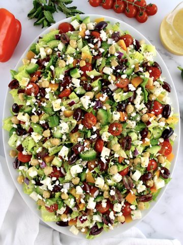 overhead view of Mediterranean Chopped Salad on white oval platter