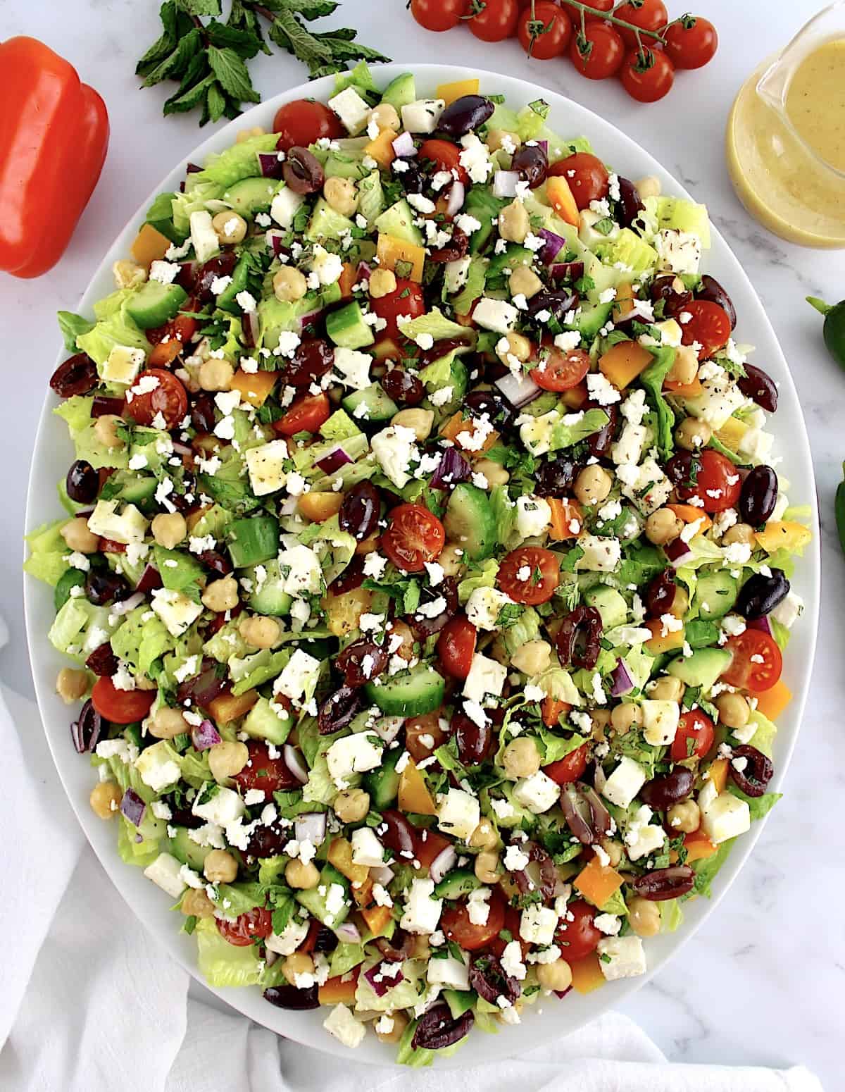 overhead view of Mediterranean Chopped Salad on white oval platter