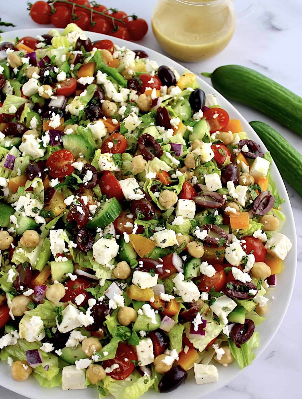 overhead view of Mediterranean Chopped Salad in white oval platter