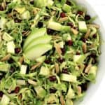 Shredded Brussels Sprouts Salad with 3 sliced green apples in center