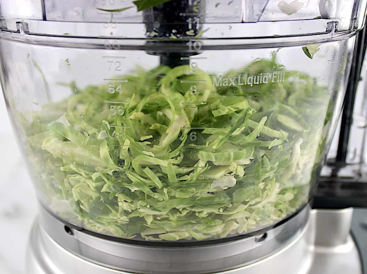 Shredded Brussels Sprouts in food processor bowl