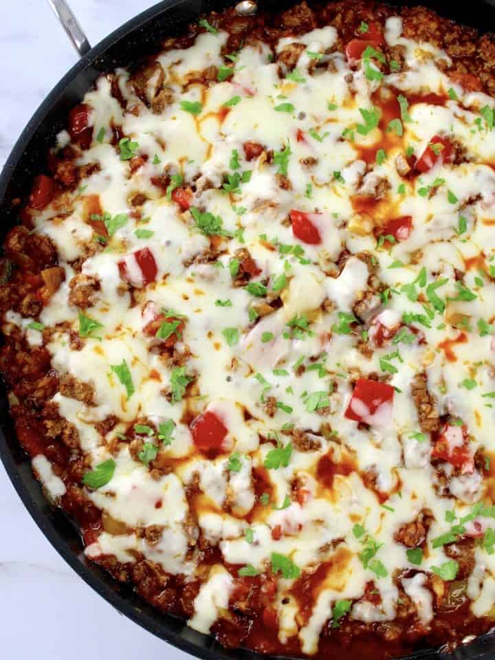 Stuffed Pepper Skillet in pan with melted cheese and chopped parsley on top