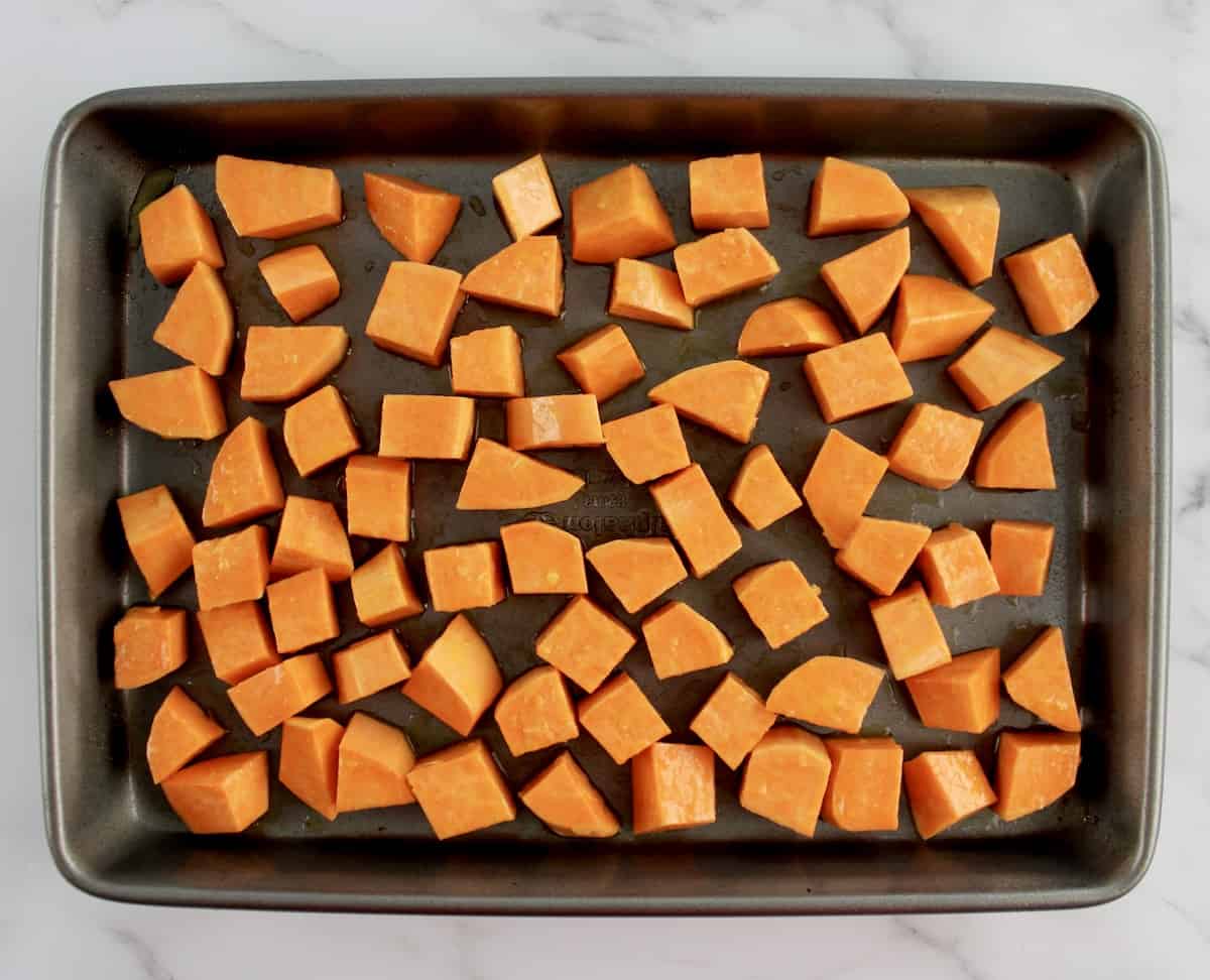 sweet potato cubes on baking sheet uncooked