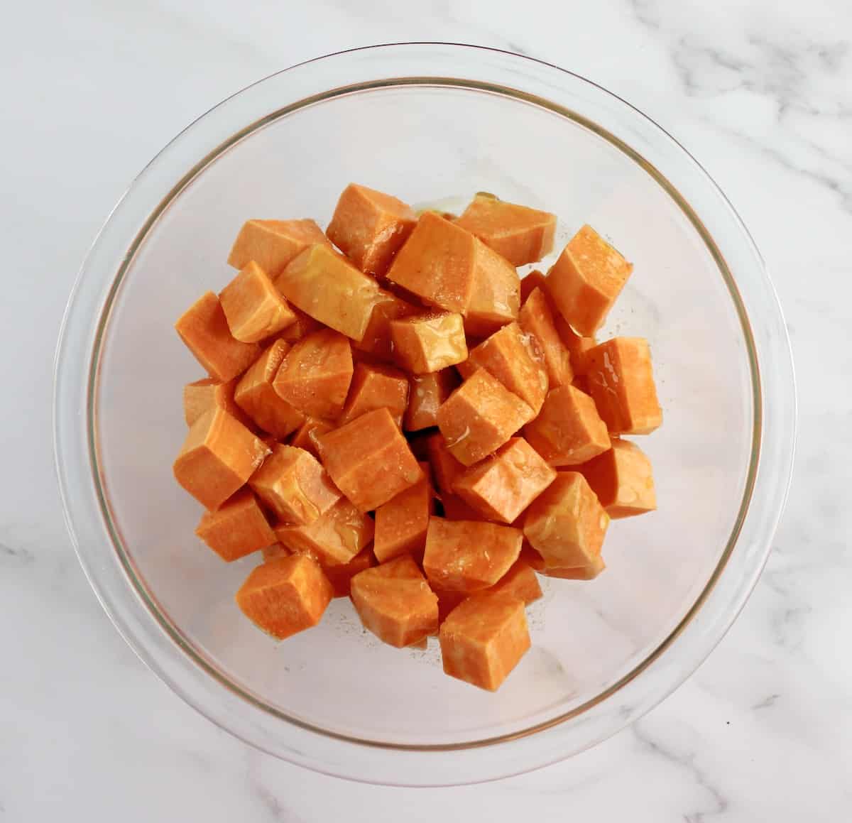 sweet potato cubes in bowl with butter and salt