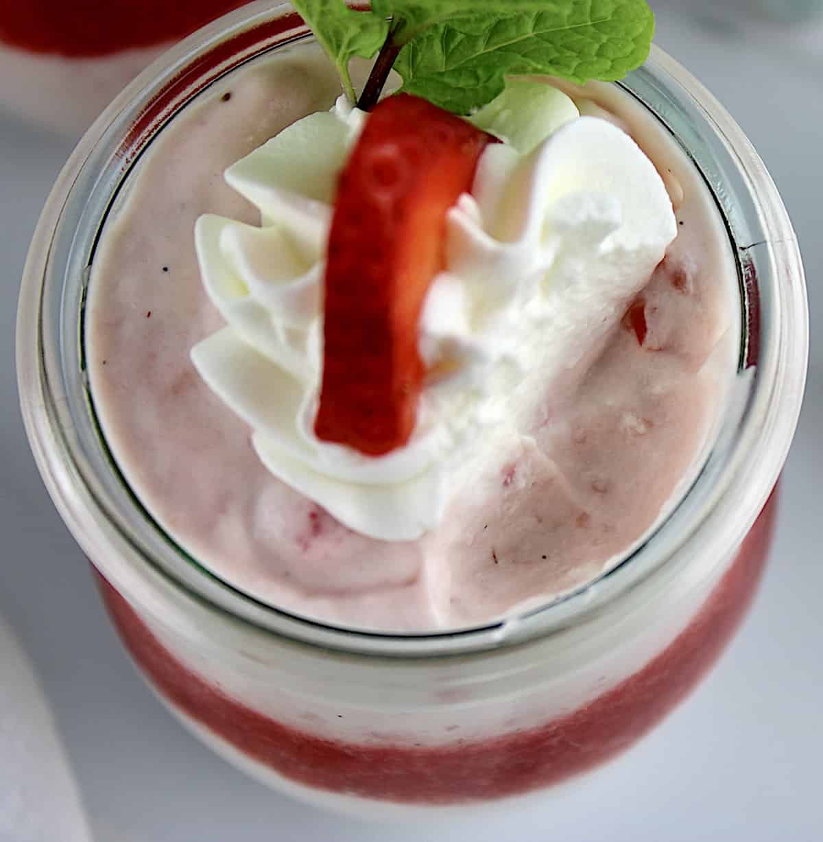 Easy Strawberry Mousse in glass jar with bite missing