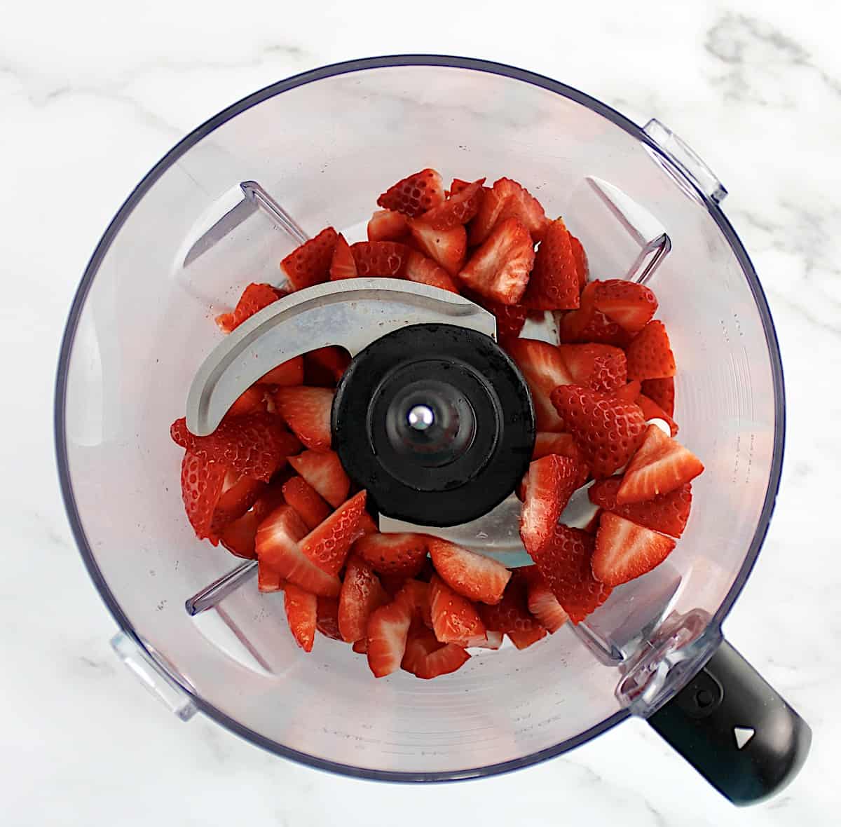 chopped strawberries inn food processor bowl