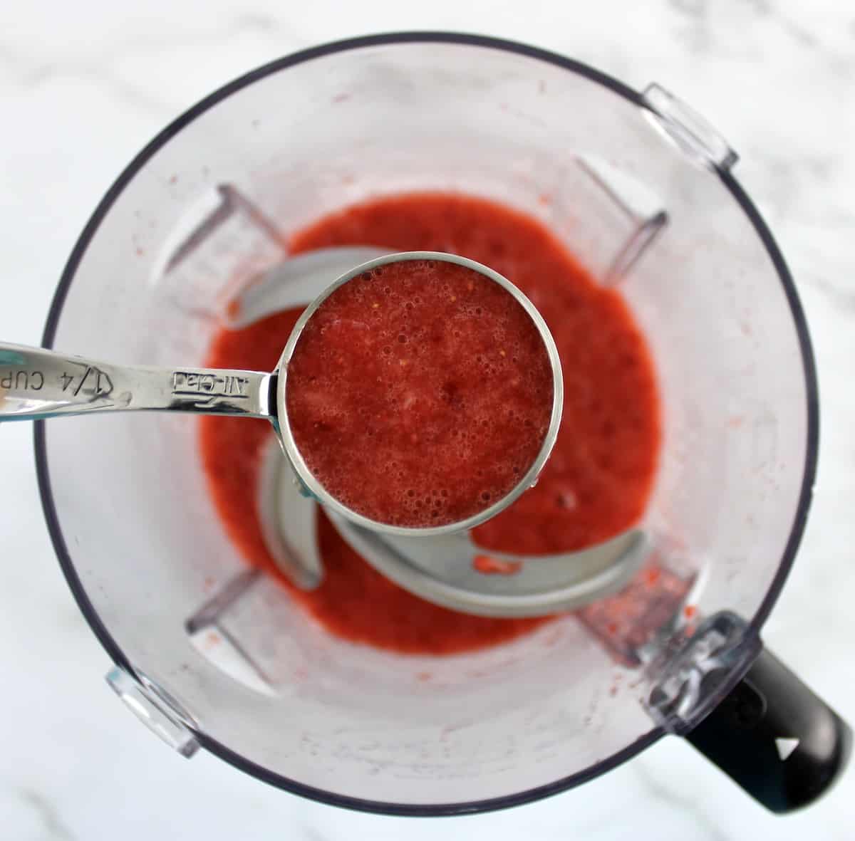 strawberry puree i measuring cup over food processor