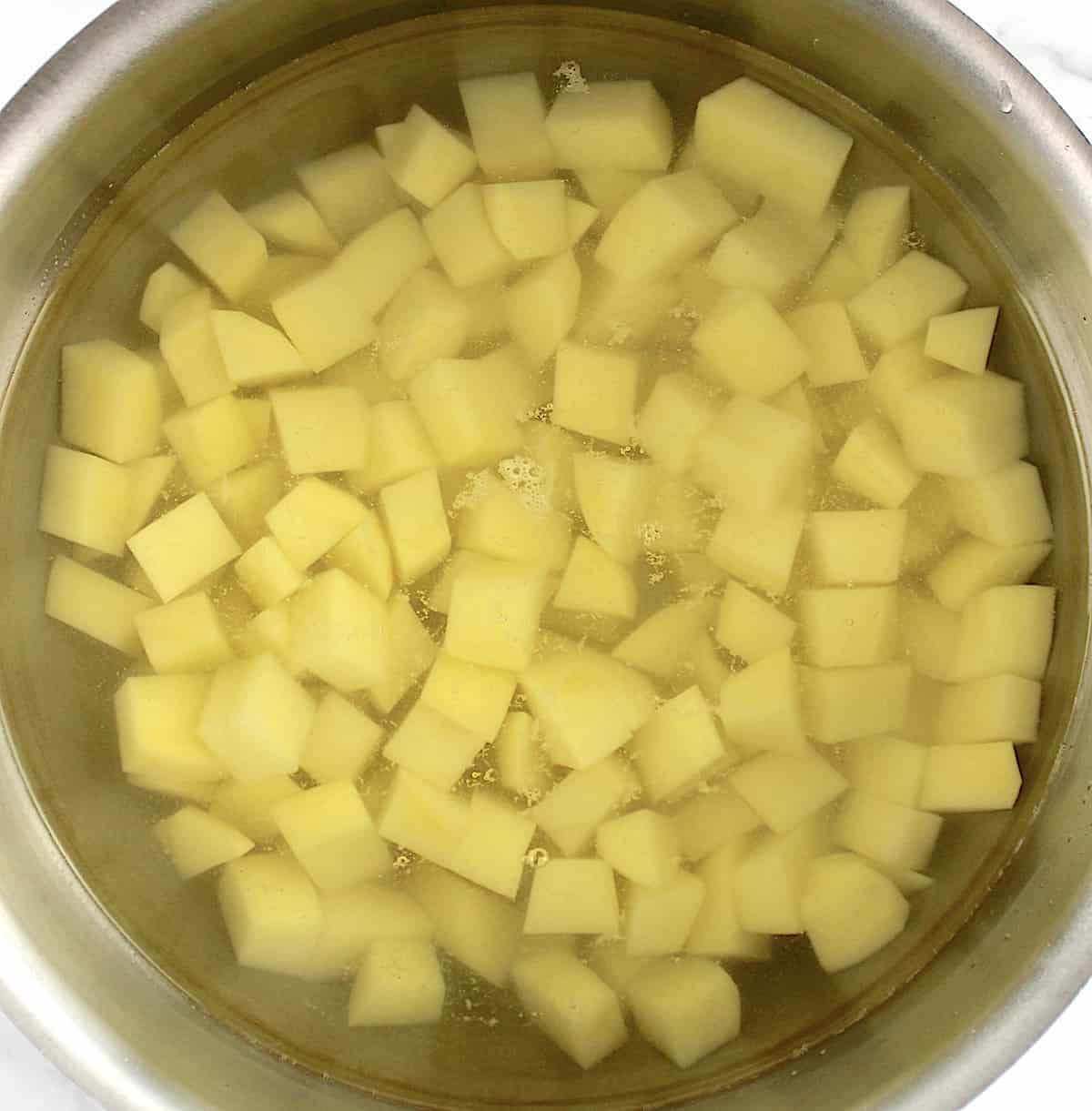 diced gold potatoes in saucepan with water