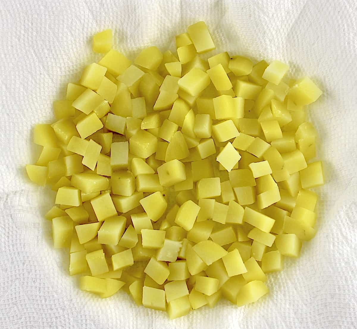 cooked diced gold potatoes on paper towels