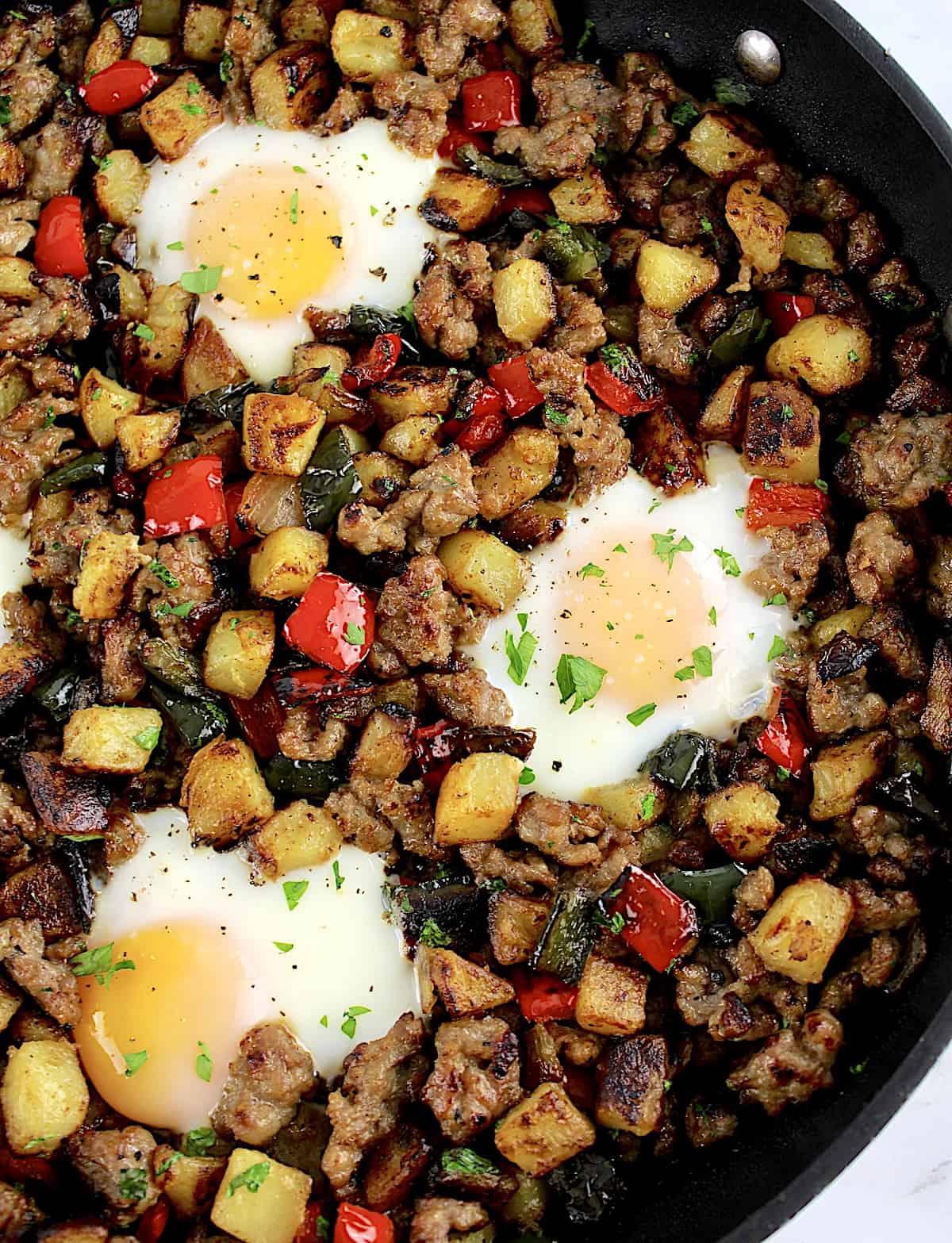 closeup of Italian Sausage and Peppers Hash with 3 eggs