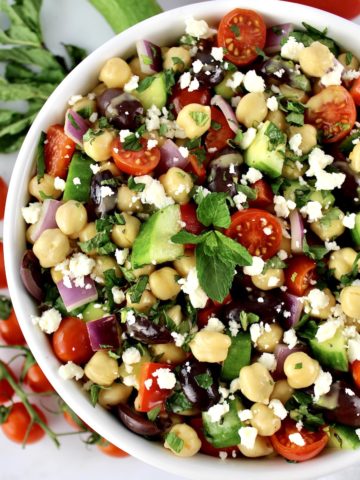 Chickpea Salad in white bowl with veggies in background