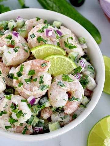 Lime Cilantro Shrimp Salad in bowl with 2 small lime slices
