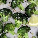 Oven Roasted Broccoli on baking sheet with small lemon slice