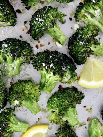Oven Roasted Broccoli on baking sheet with small lemon slice