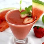 Watermelon Smoothie in glass with watermelon and strawberry garnish