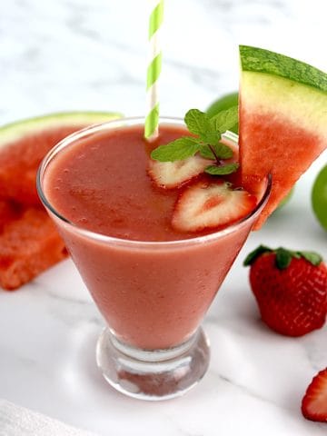 Watermelon Smoothie in glass with watermelon and strawberry garnish