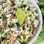 overhead view of Cilantro Lime Coleslaw with 2 lime slices in white bowl