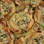 closeup of pork marsala with chopped parsley on top