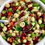 overhead view of Easy Bean Salad in spoon held up over salad