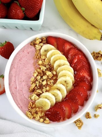 overhead view of Strawberry Banana Smoothie Bowl with strawberries and bananas sliced