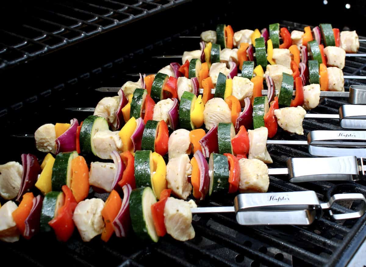8 raw Greek Chicken Kebabs on grill