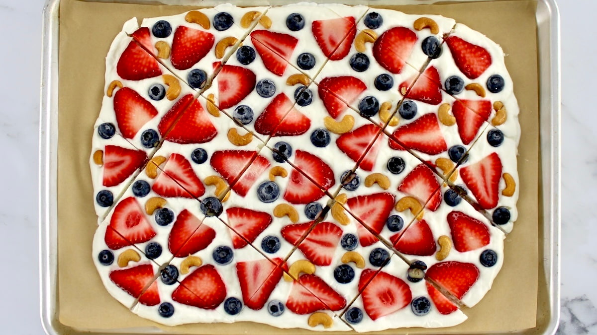 Frozen Yogurt Berry Bark on parchment paper cut into pieces