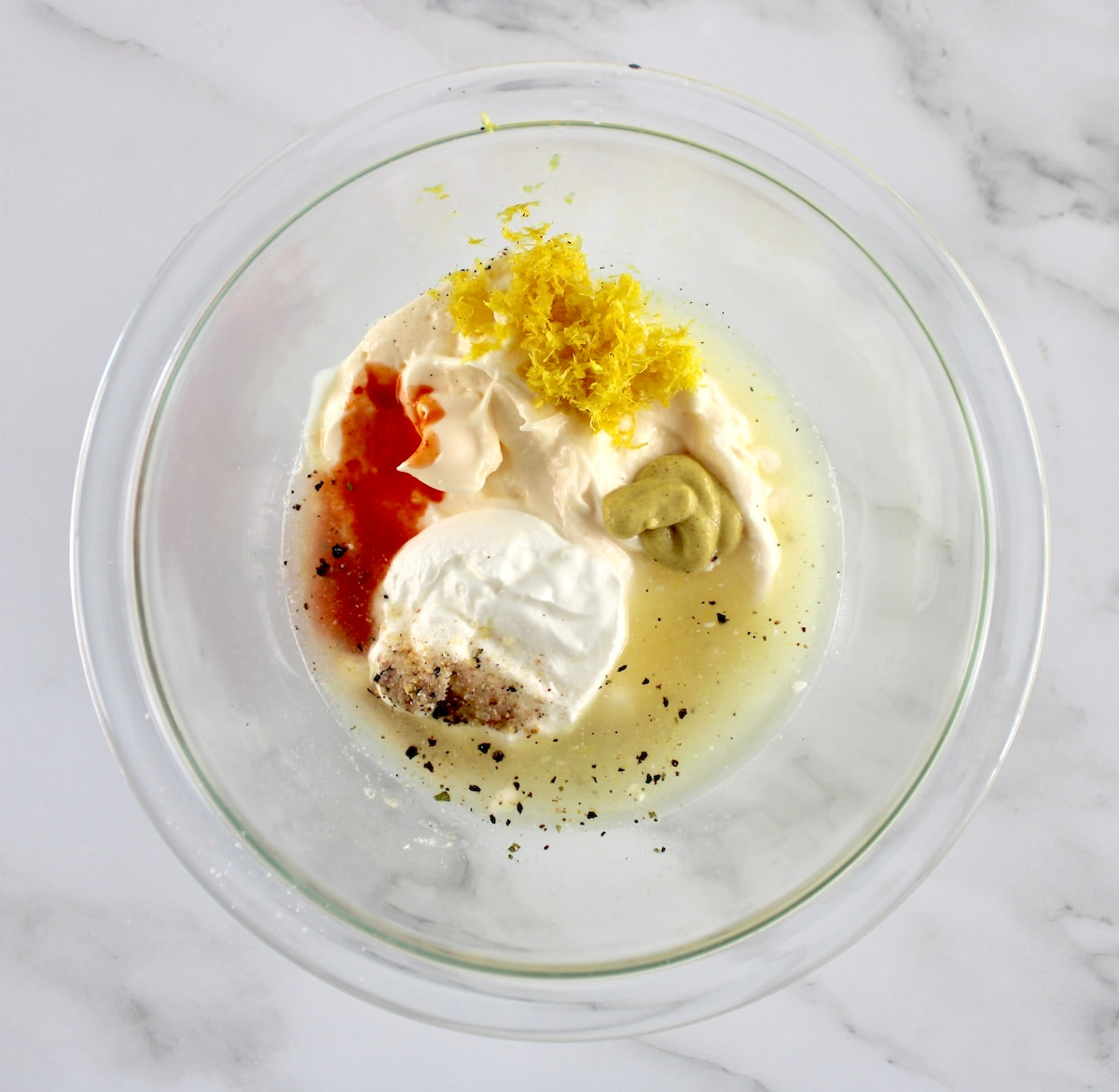 Crab Salad Stuffed Avocados dressing ingredients in glass bowl unmixed