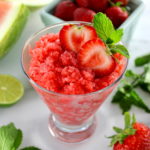 Strawberry Watermelon Granita in glass with strawberries, lime and mint in back