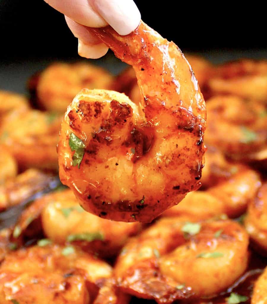 Chili Lime Shrimp being held up over skillet
