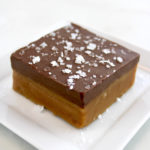 Chocolate Peanut Butter Bar on white plate with flaked salt on top