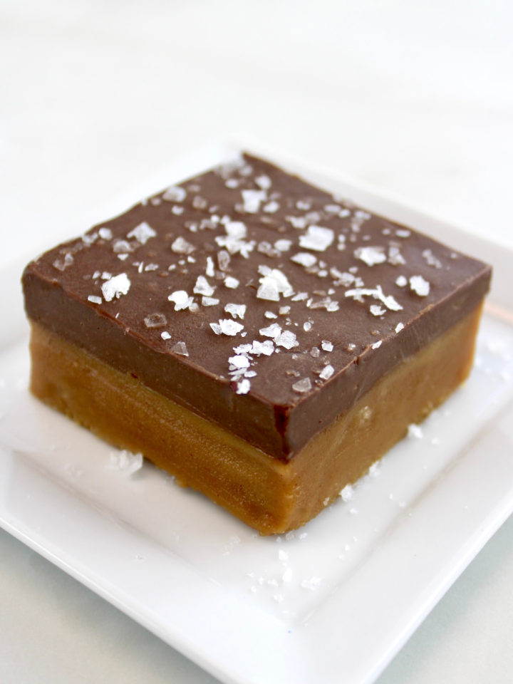 Chocolate Peanut Butter Bar on white plate with flaked salt on top