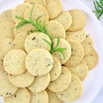 Rosemary Garlic Crackers on white plate with rosemary sprigs