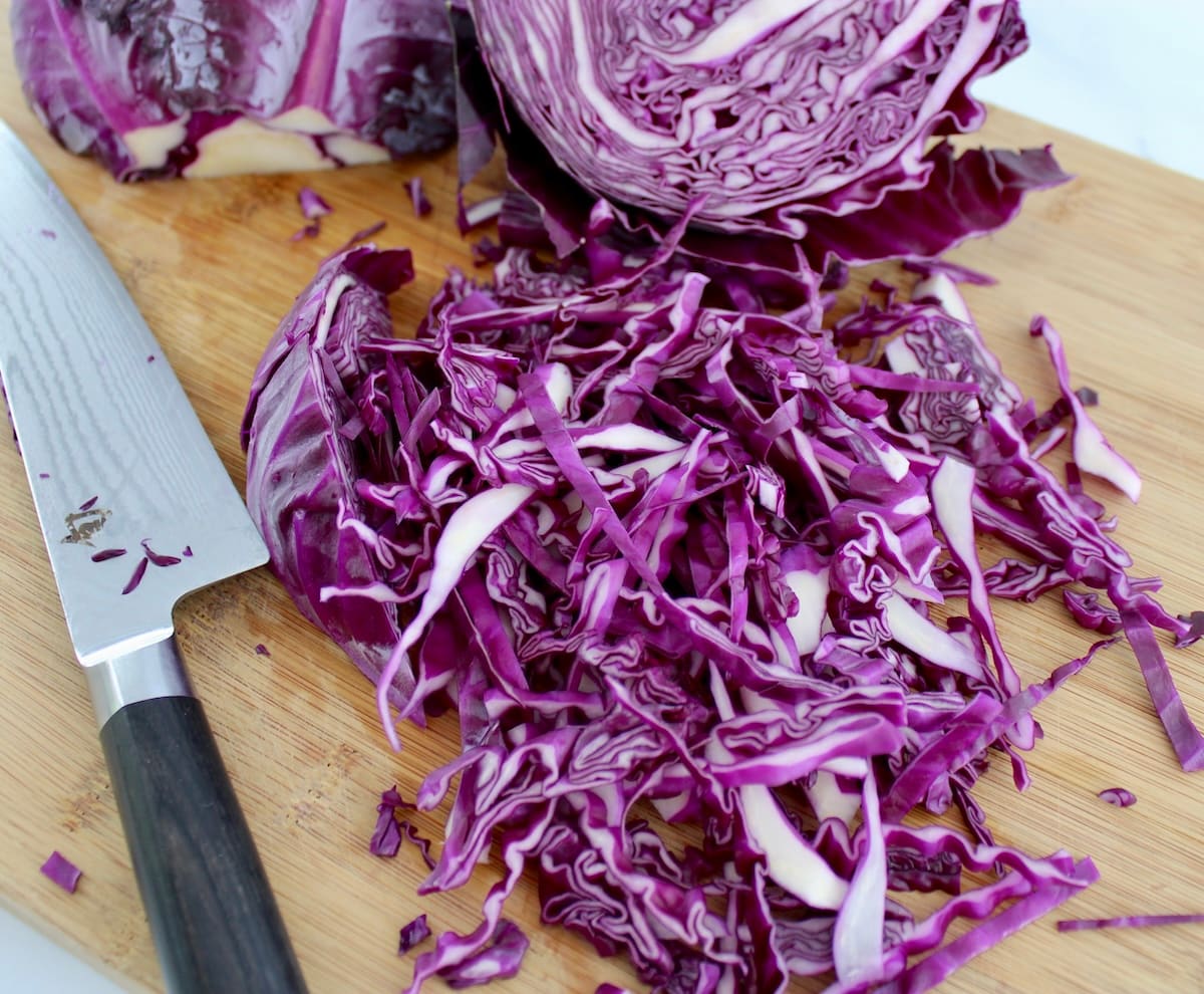 shredded red cabbage on cutting board