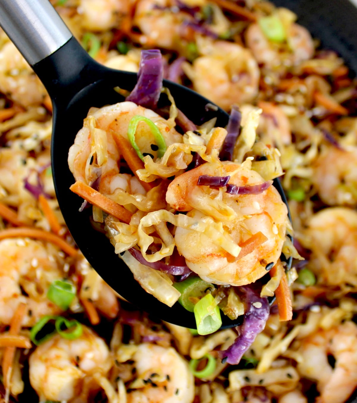 serving spoon holding up Shrimp Egg Roll in a Bowl